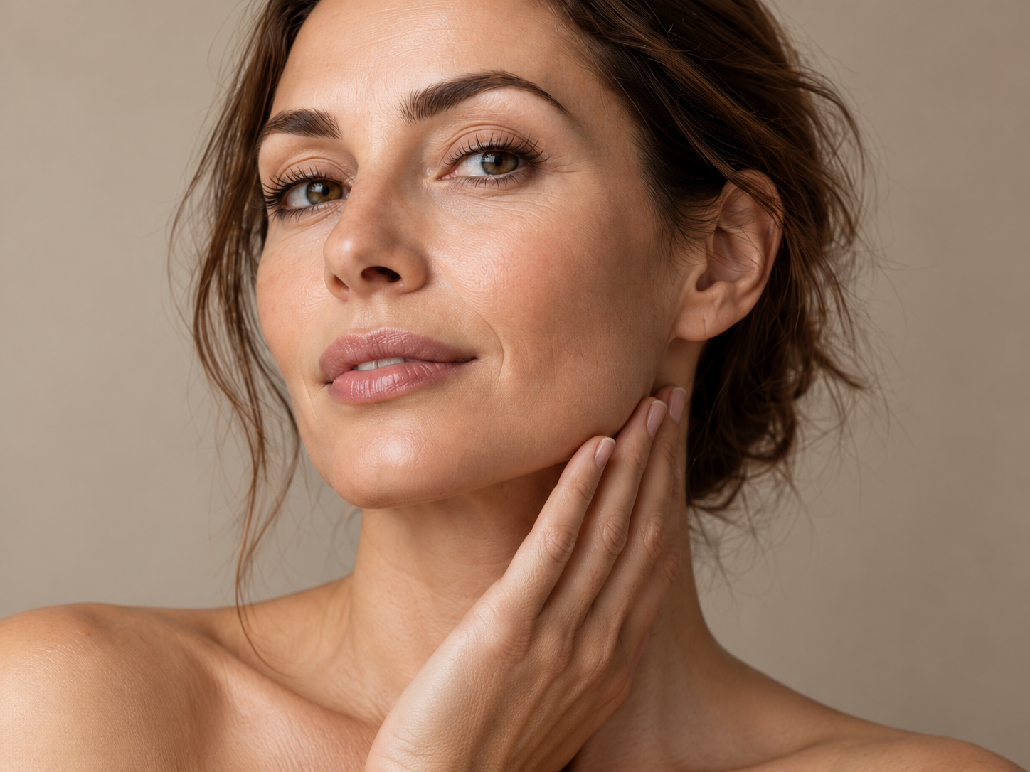 Woman with hand gently resting along her jawline